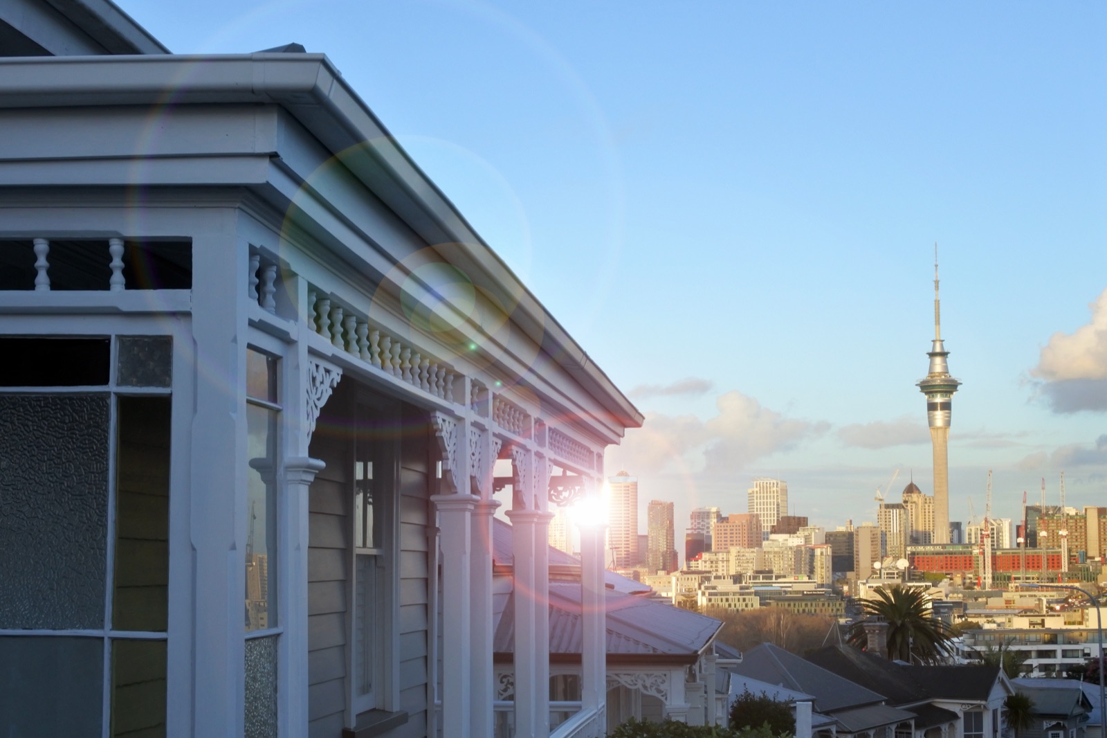Traditional Auckland villa with the Sky Tower visible in the city skyline beyond